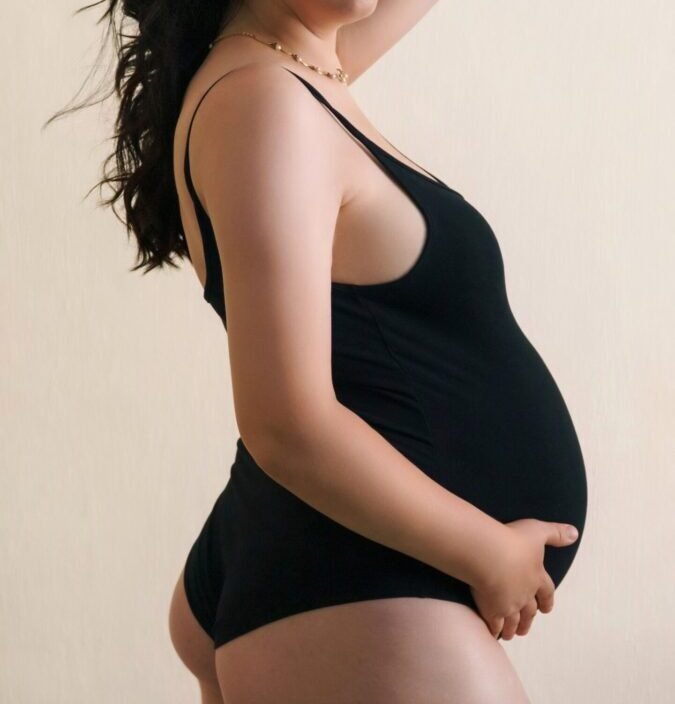 pexels photo 28886895 28886895 Portrait of a pregnant woman wearing a black bodysuit posing confidently against a neutral background.